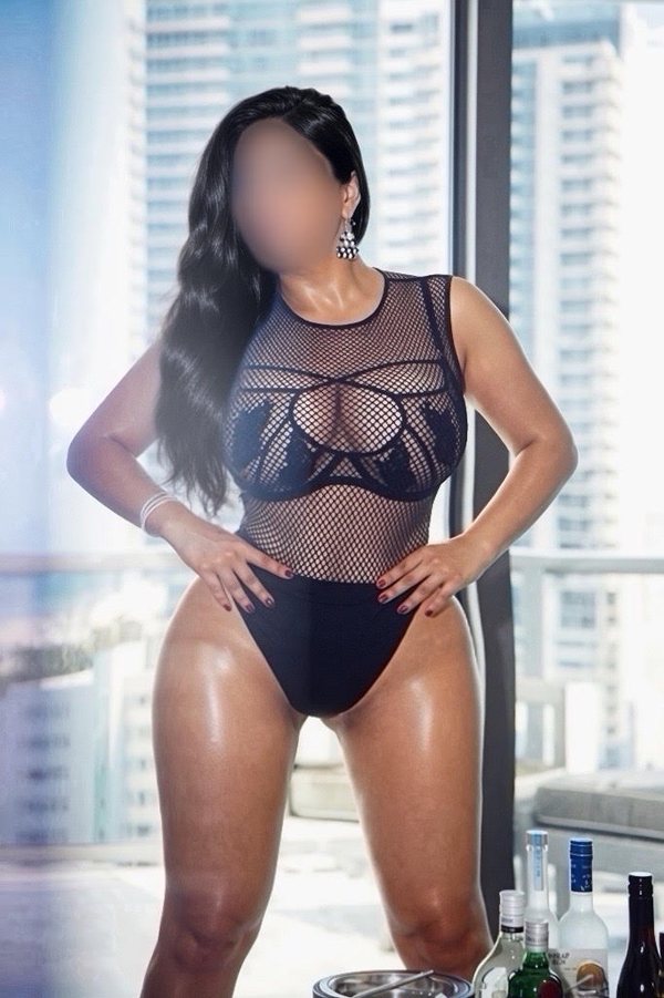 Black mesh bodysuit by a city window